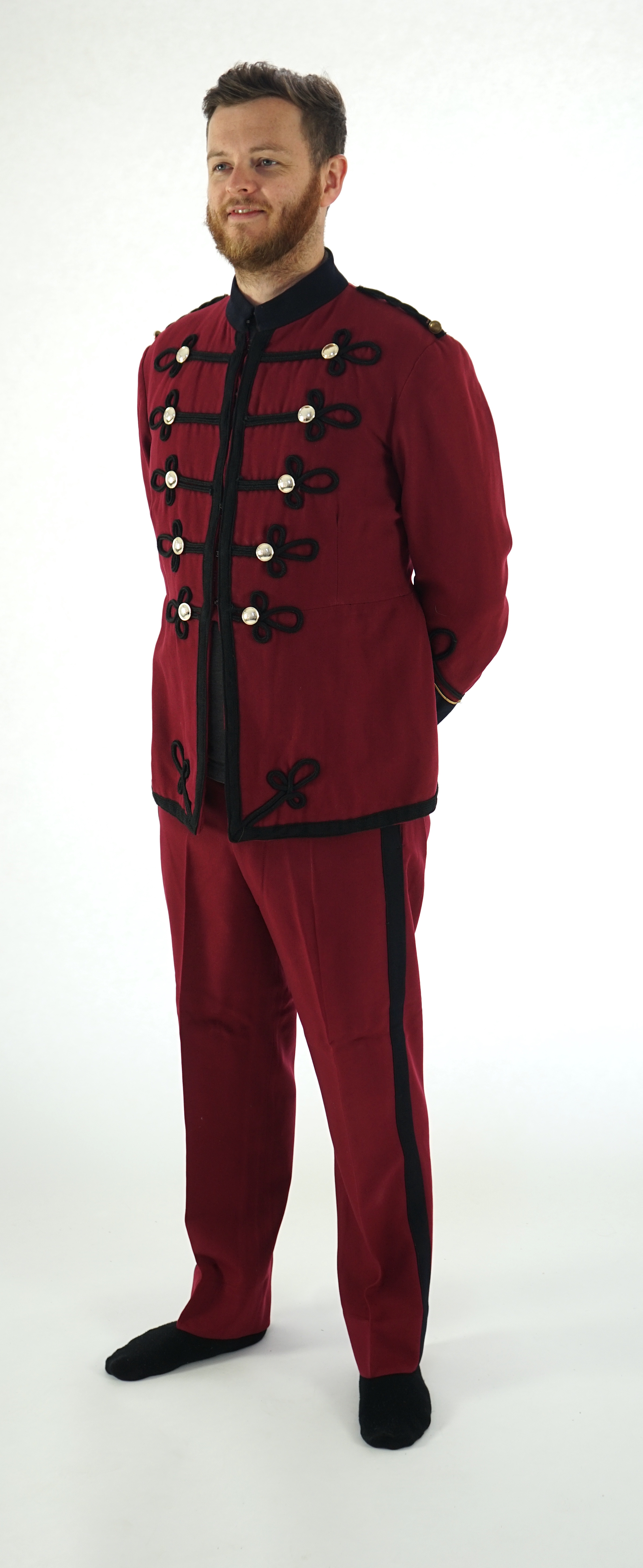 An early 20th century burgundy and black trim Military/Bandsman's uniform jacket and trousers.